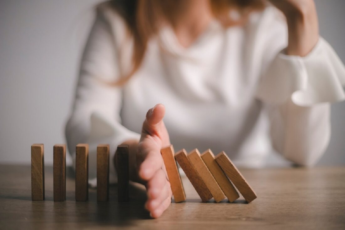 Risk,And,Strategy,In,Business,,Hand,Stopping,Wooden,Block,Domino