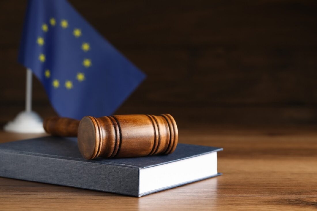 Judge's,Gavel,And,Book,On,Wooden,Table,Against,European,Union