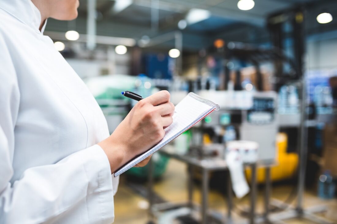 Young,Happy,Female,Worker,In,Factory,Writing,Notes,About,Water