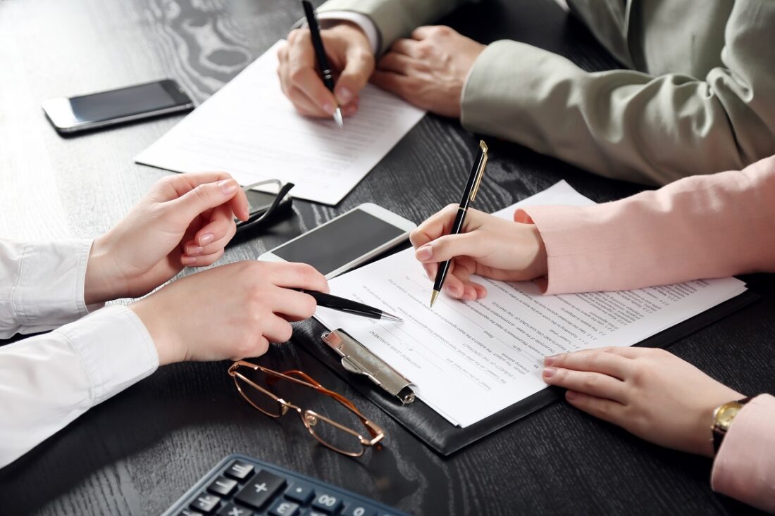 Human,Hands,Working,With,Documents,At,The,Desk,Closeup