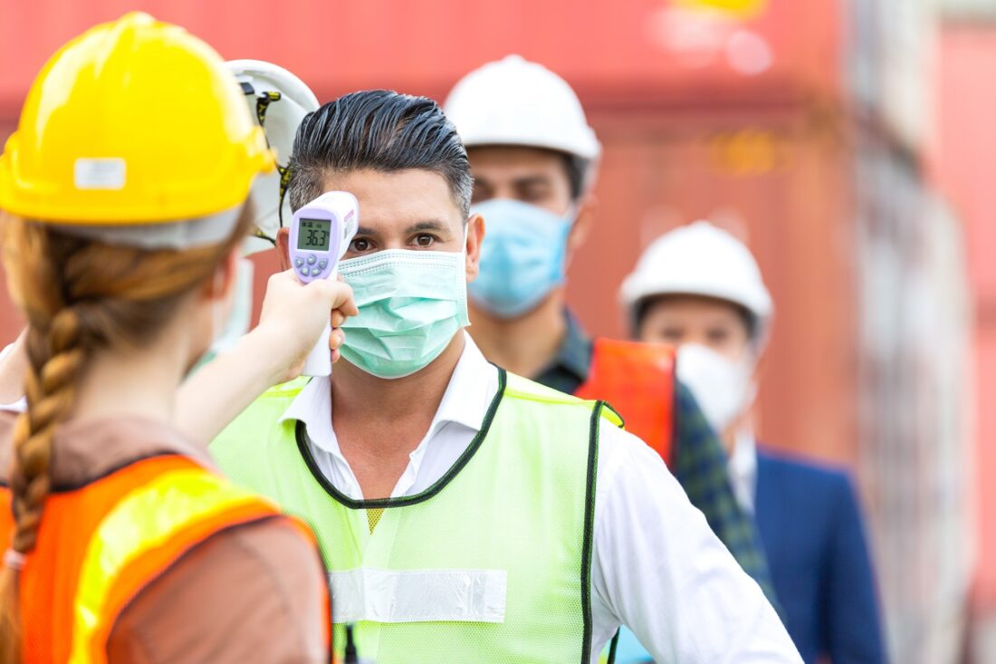 Female,Worker,Scanning,Fever,Temperature,With,Digital,Thermometer,To,Construction