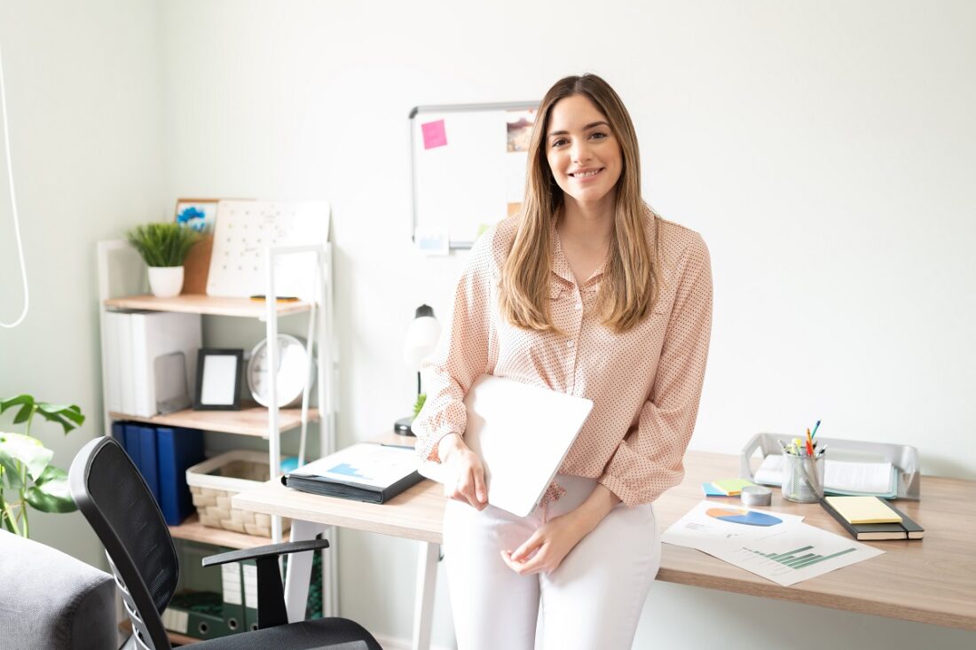 Cute,Woman,Working,As,An,Administrative,Assistant,Holding,A,Laptop