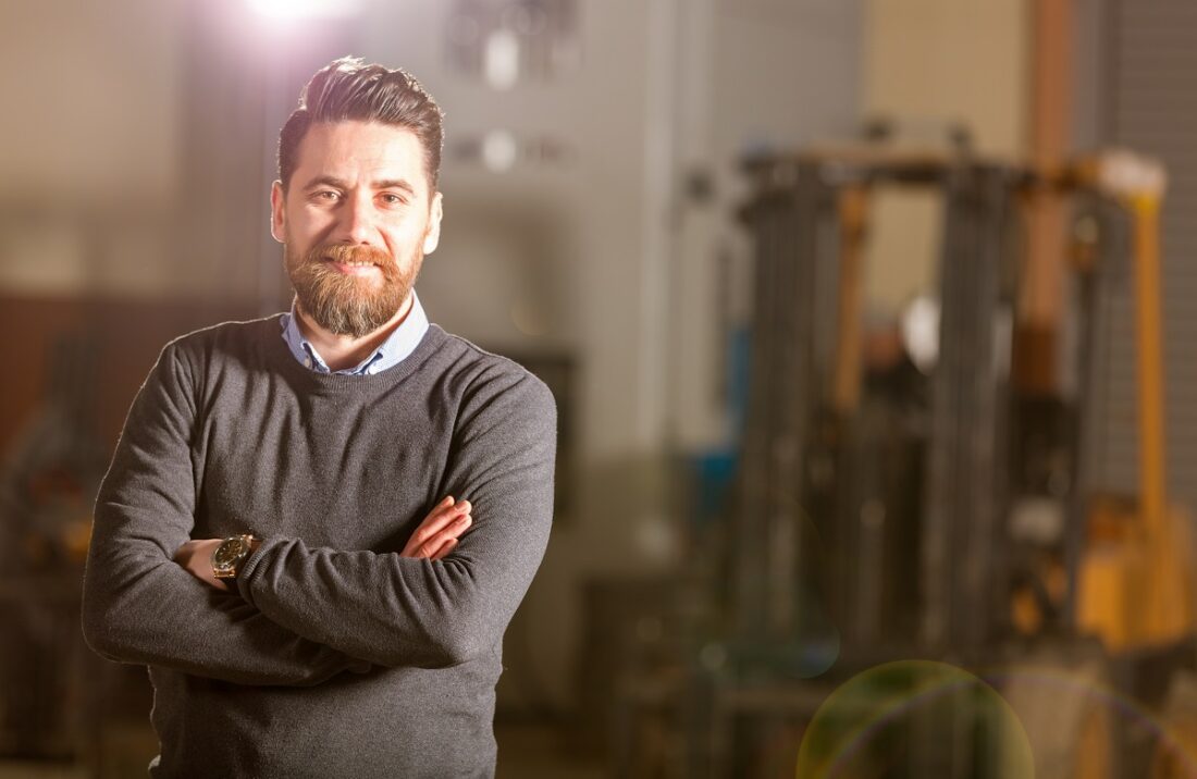 Young,Businessman,Posing,In,Factory.