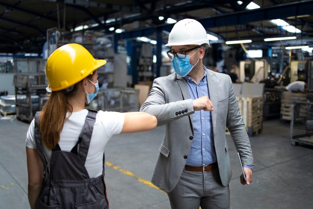 Factory,Manager,And,Worker,Greeting,Each,Other,With,Elbow,Bump