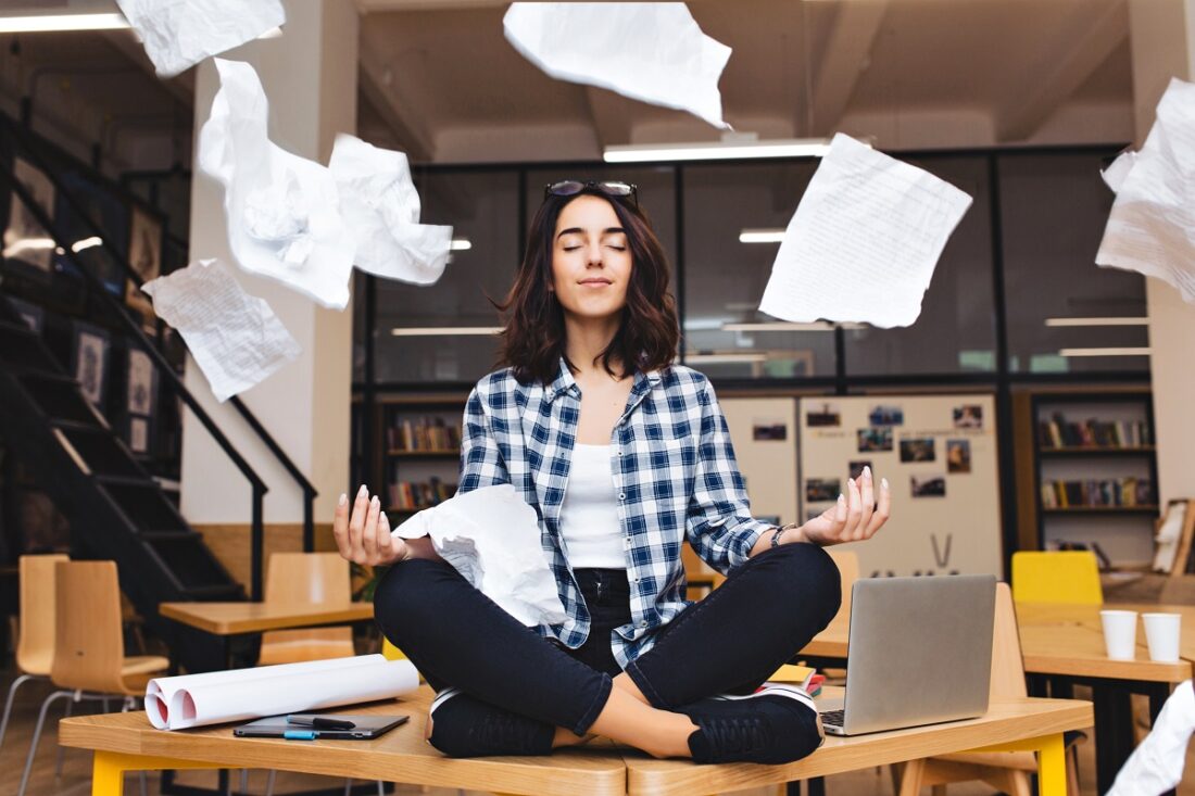 Young,Pretty,Joyful,Brunette,Woman,Meditating,On,Table,Surround,Work