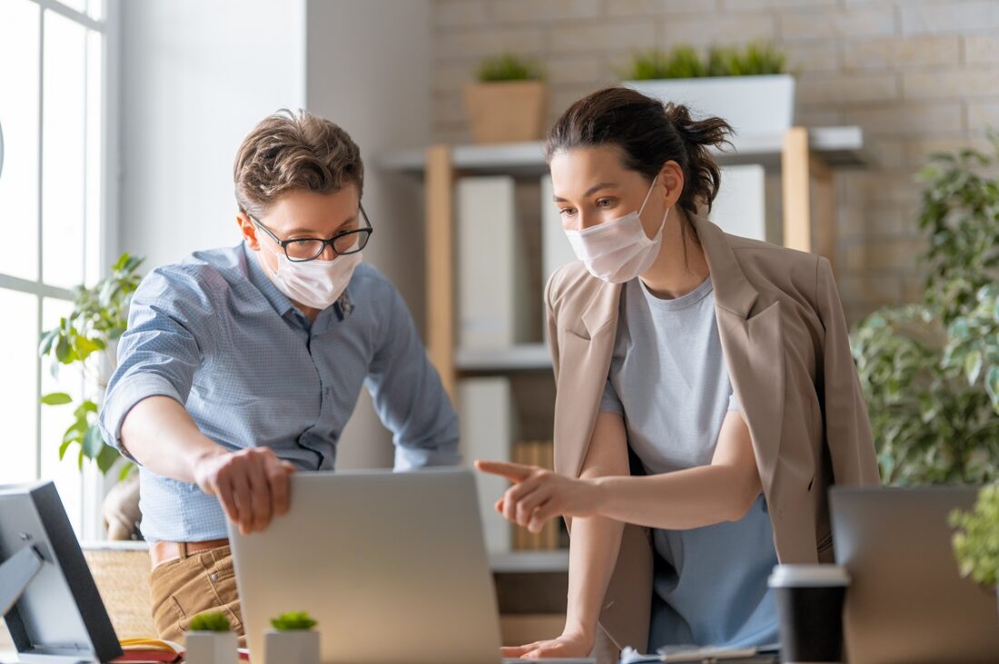 Businessman,And,Businesswoman,With,Medical,Mask,Working,In,Office.,Covid-19