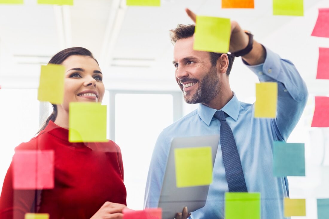 Couple,Of,Coworkers,Brainstorming,Together,In,Office