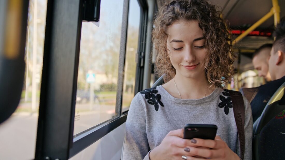 A,Young,Lady,Using,A,Smartphone,On,The,Bus.,Medium