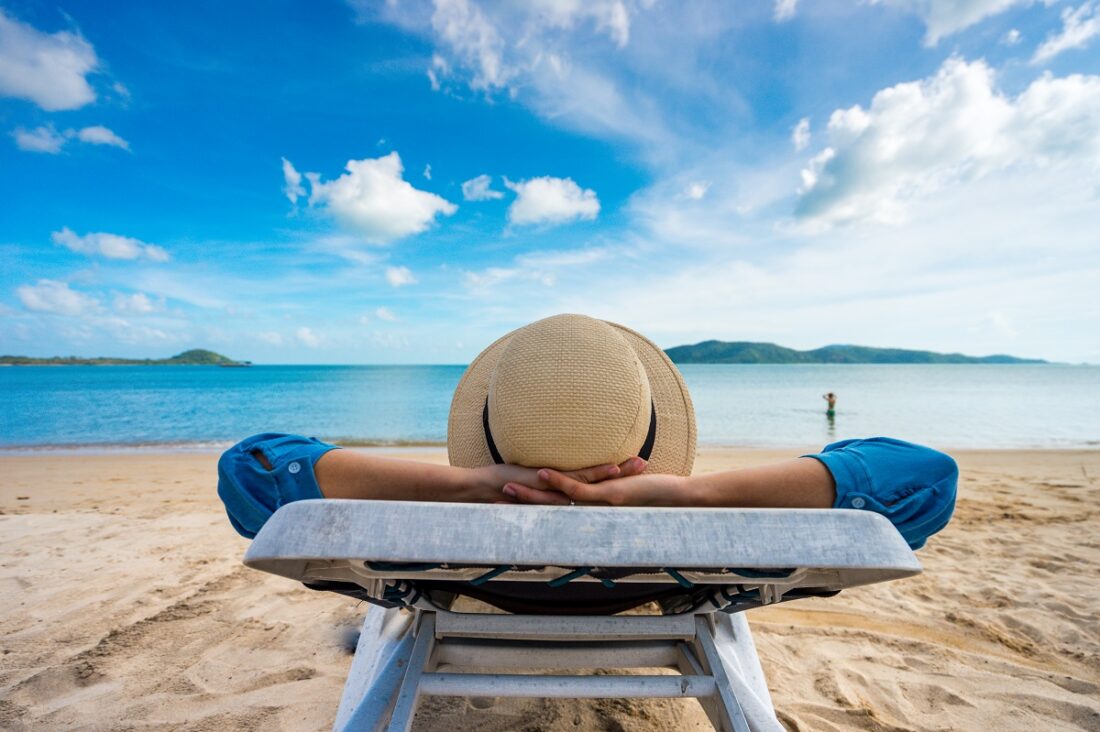 Young,Woman,Relaxing,On,Beach,,Ocean,View,,Vacation,Outdoors,Seascape