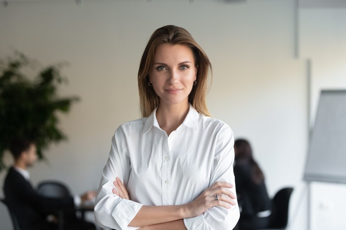 Headshot,Portrait,Of,Confident,Young,Businesswoman,Stand,Forefront,With,Arms