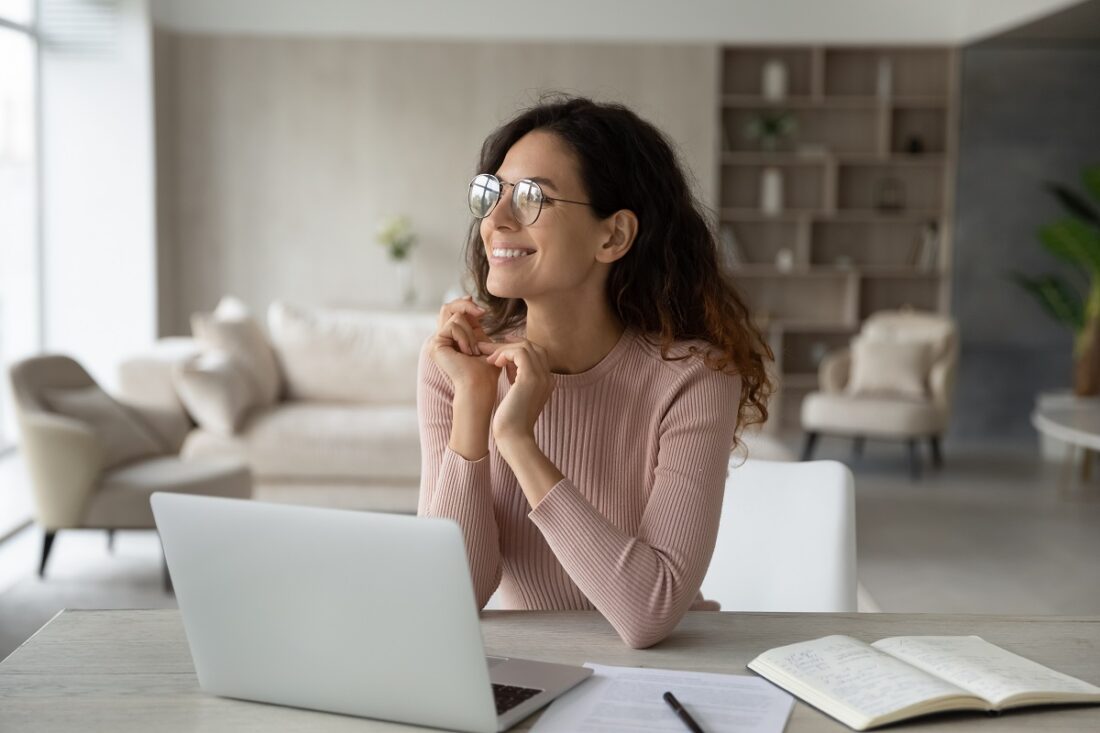 Smiling,Dreamy,Confident,Businesswoman,In,Glasses,Looking,To,Aside,,Sitting