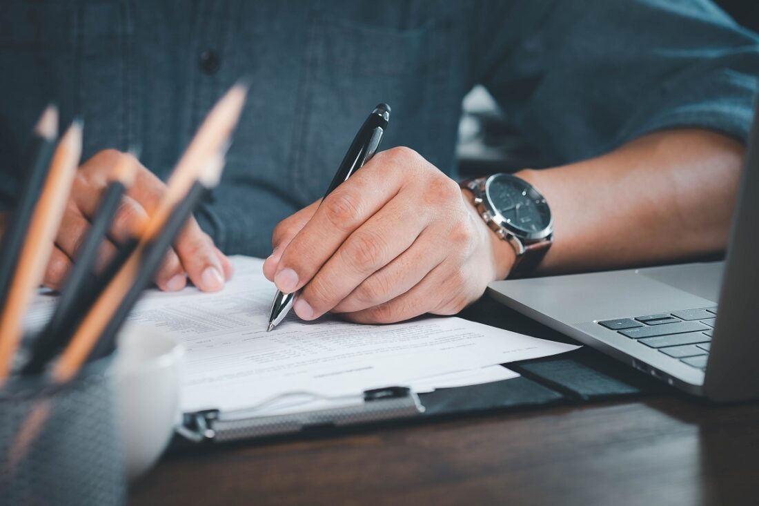 Close-up,Of,Hand,Using,Writing,Pen,With,Questionnaire,Or,Paperwork