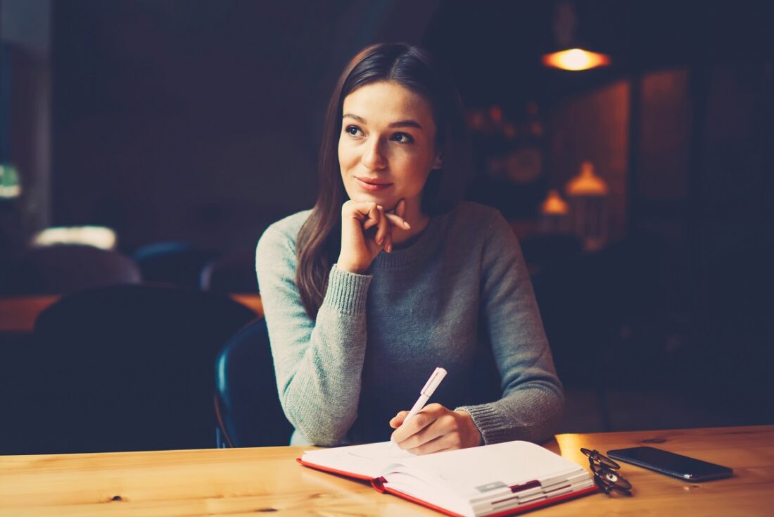 Pondering,Attractive,Young,Woman,With,Pen,In,Hand,Thinking,On