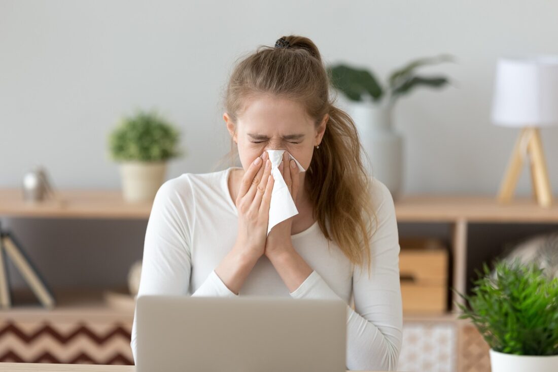 Ill,Young,Woman,Caught,Cold,Sneezing,In,Tissue,At,Home