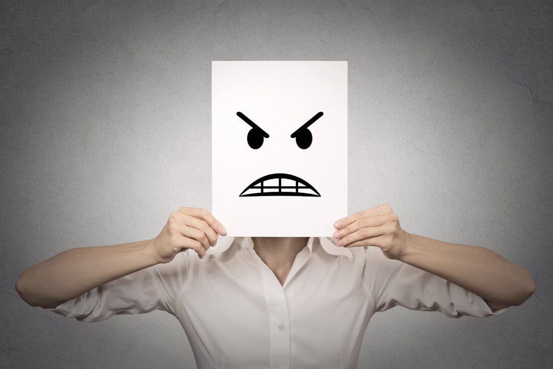 Businesswoman,Covering,Her,Face,With,Angry,Mask,Isolated,Grey,Wall