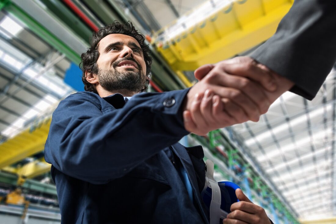 Portrait,Of,A,Man,Giving,An,Handshake,In,An,Industrial