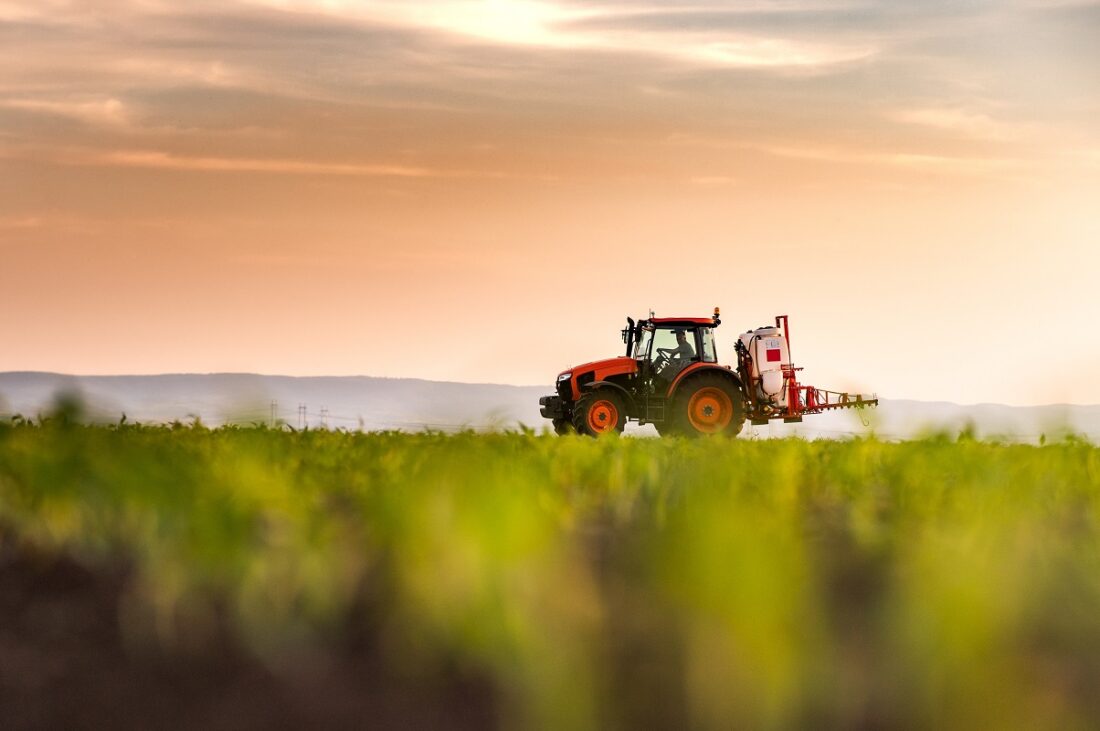 Tractor,Spraying,Pesticides,On,Corn,Field,With,Sprayer,At,Spring