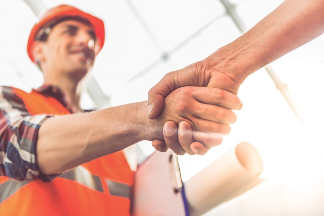 Handsome,Construction,Workers,In,Protective,Helmets,And,Vests,Are,Shaking