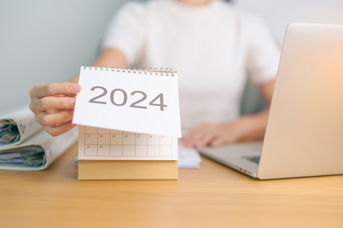 2024,Year,Calendar,On,Table,With,Business,Woman,Using,Laptop