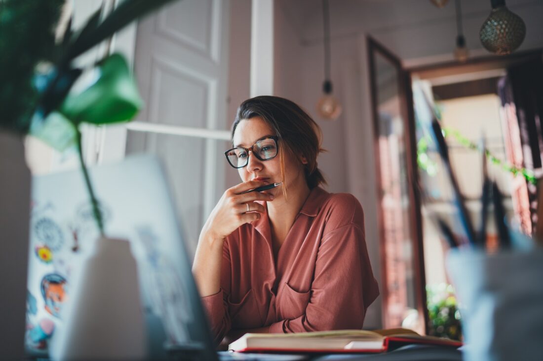 Young,Businesswoman,Thinking,About,Something,While,Sitting,Front,Open,Portable