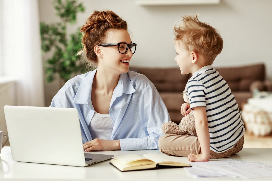 Cheerful,Female,Entrepreneur,And,Little,Boy,Smiling,And,Typing,On