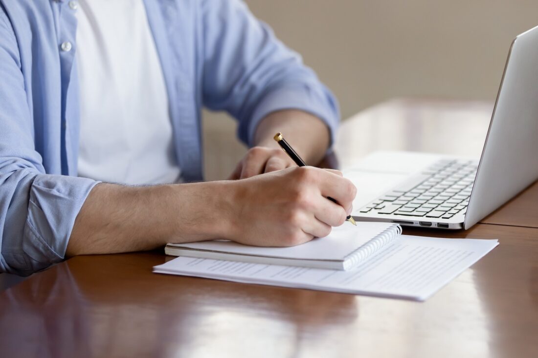 Close,Up,Of,Concentrated,Male,Student,Busy,Studying,Using,Laptop