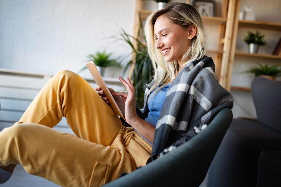 Happy,Young,Woman,Using,Tablet,Pc,In,Loft,Apartment