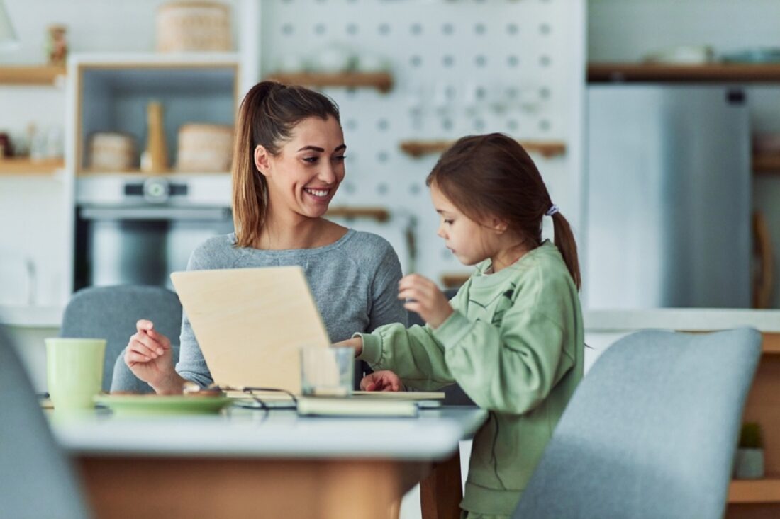 A,Happy,Mother,Helping,Her,Daughter,Study,Using,A,Wooden