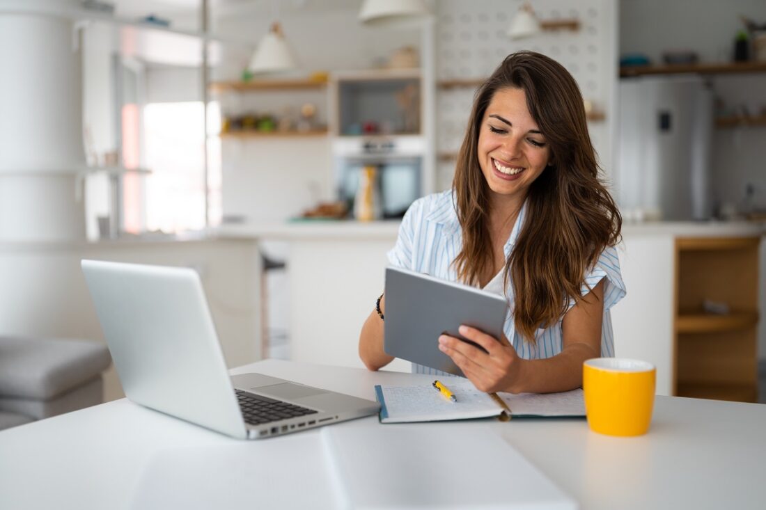 Female,Business,Person,Using,Digital,Tablet,And,Laptop,Or,Remote